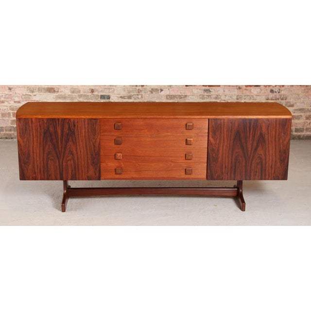 Mid Century rosewood and teak sideboard with curved ends by Vanson, circa 1960s. 4 drawers with carved teak handles and 2...