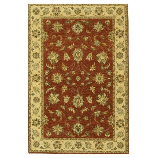 This hand knotted pile rug features a primary color palette of coral, salmon, and pink tones. Crafted from wool, this Agra...