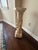 Plaster pedestal stand features an intricate relief of blooming flowers and lush foliage, finished in a soft cream tone...