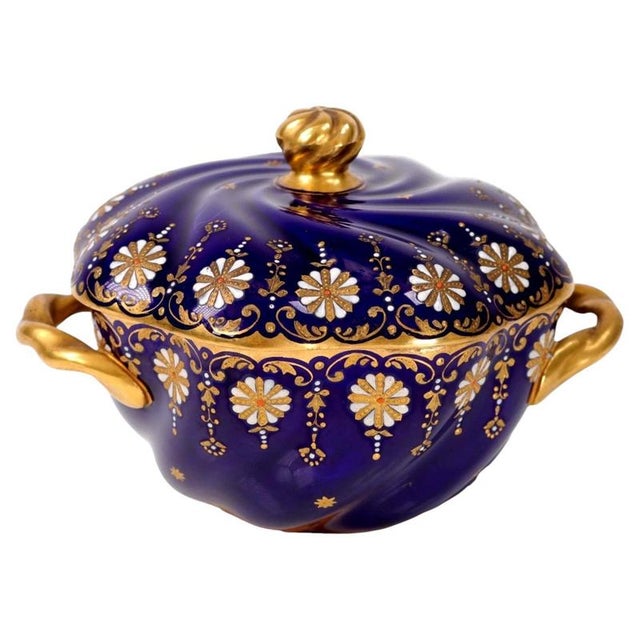 Swirling spiral fluting gives dramatic movement to this Coalport porcelain covered bowl, finished in a rich underglaze...