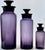 Graduated set of three mid-century Italian amethyst glass apothecary bottles, likely Empoli, circa 1960s. Rich, saturated...