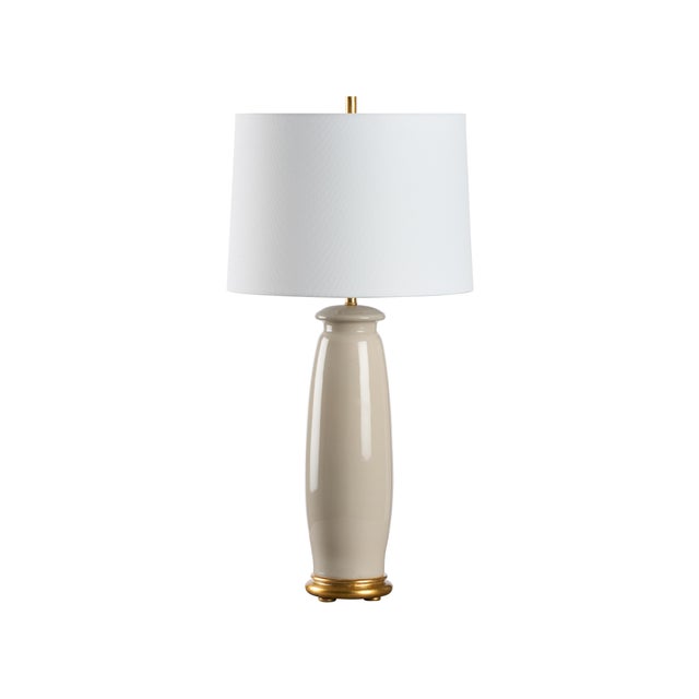 This lovely ceramic lamp exudes sleek sophistication with its smooth, minimalist silhouette. Its elegant gold base adds a...