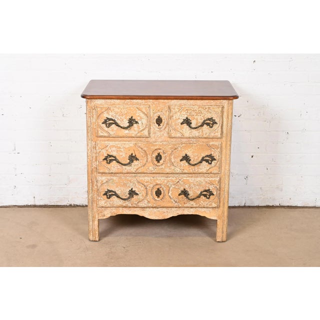 An exceptional French Country or French Provincial Louis XV style three-drawer nightstand or chest of drawers By Minton...