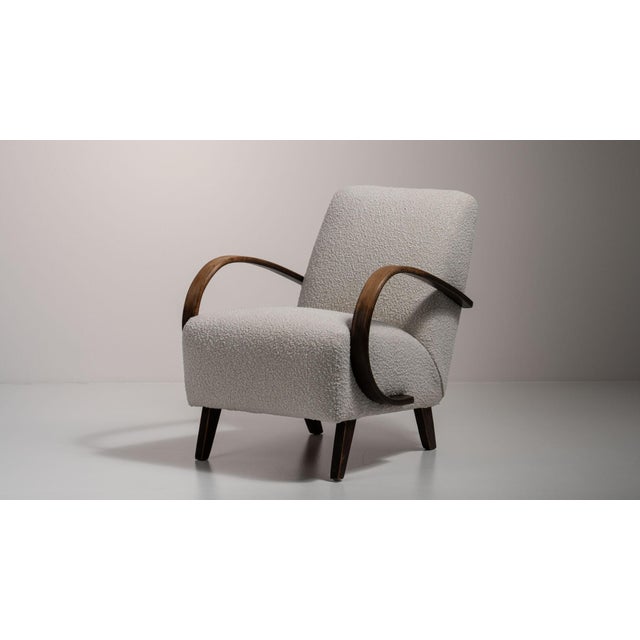 A gray wood armchair by Jindřich Halabala, dating to the 20th century and made in Czechia. The wood frame is finished in...