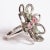 Unusually cut and faceted green aquamarine and morganite stones create the center of this flower ring. The petals are...