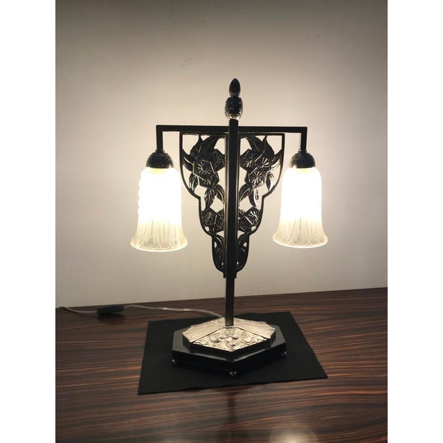 French Art Deco table lamp by Georges Leleu. Having two shades in frosted glass with polished details having geometric...