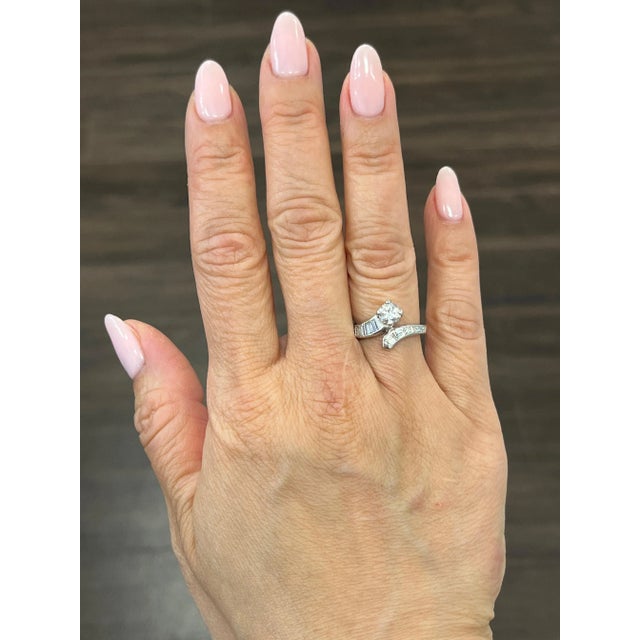 This elegant ring features a stunning round diamond, with a total weight of 0.45 carats, set in 14k white gold. The white...