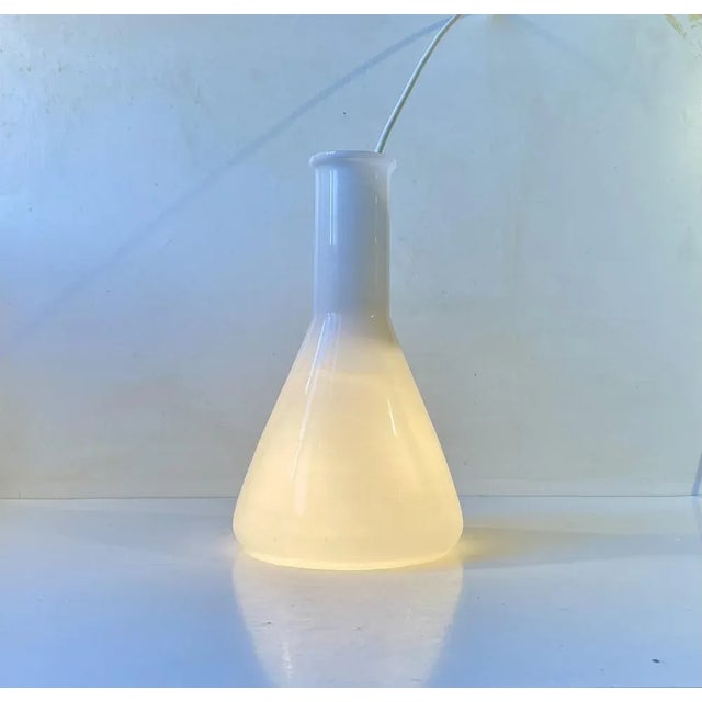 Organically shaped pendant lamp in white opaline glass. Made by Holmegaard in Denmark during the 1960s. Possibly based a...