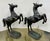 Striking pair of vintage metal prancing horse sculptures. Each piece features a dynamic, rearing pose and intricate...