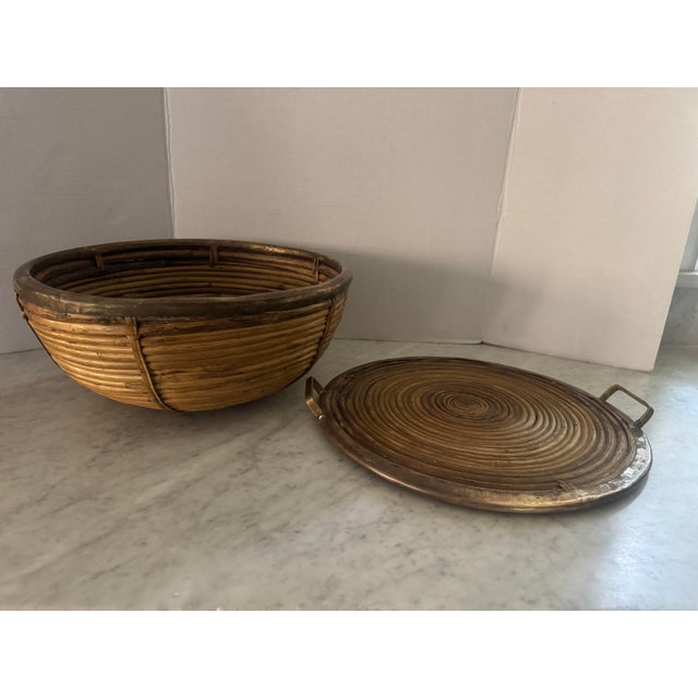 A unique vintage split reed basket with “lid” that, when removed, is a matching split reed tray with brass trim and handles.