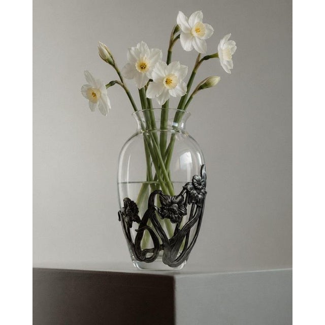 This vintage Italian glass vase from the 1970s is an elegant combination of clear glass and sculptural metalwork. Its...