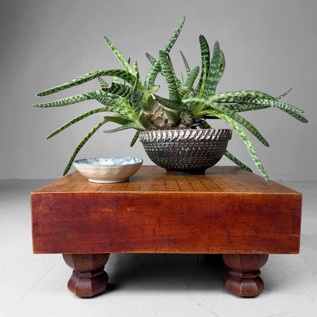 An old Japanese go-ban, a solid wooden game table for the game of Go, with a deep reddish-brown patina and a beautifully...