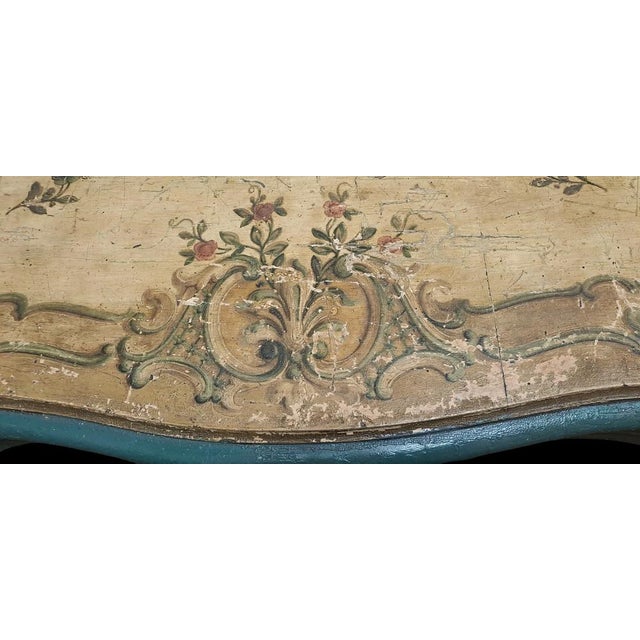 Painted wooden table. Rectangular shaped top with wavy sides and owl-beak profile. Shaped bands and "S" shaped legs with...