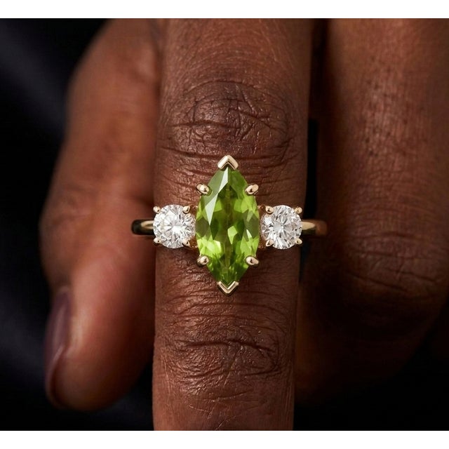 Bring a touch of fresh, vibrant elegance to your collection with this stunning three-stone ring, This design showcases a...