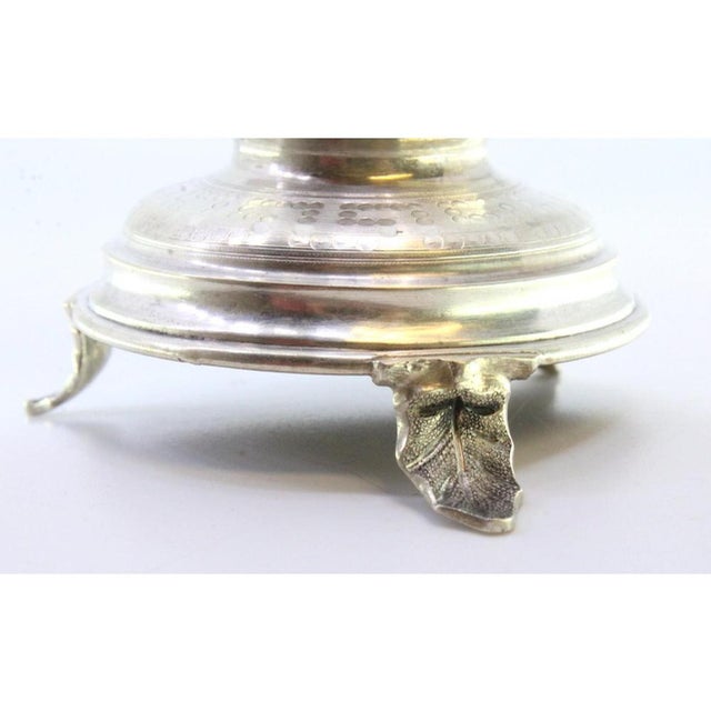 Silver toothpick holder with gilded chalice held by putti standing on a guilloche plinth and resting on three feet in the...