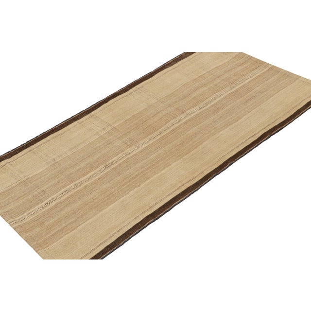 This vintage 4x7 Persian tribal kilim is handwoven in wool, and originates circa 1950-1960. The design favors neutral...