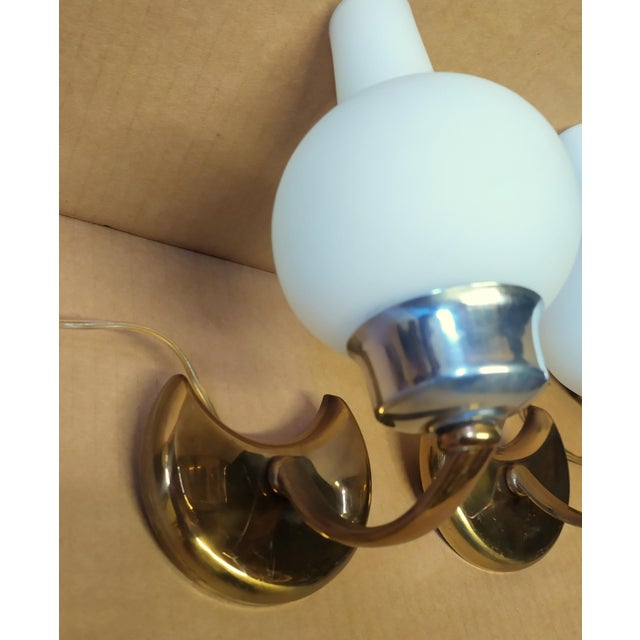 These two small Stilnovo wall lights are attributed for form and style. No logo and mark. The lamps operate with their...