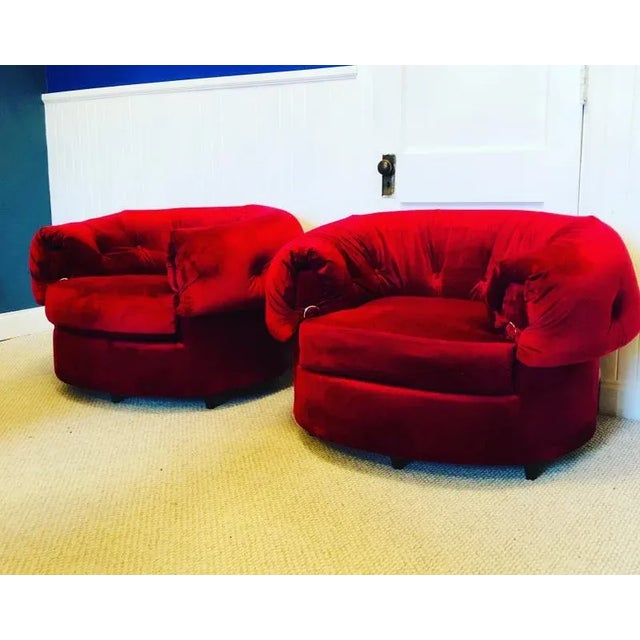 Pair of large Scale Button Tufyed Polar Bear Style lounge chairs. Freshly Upholstered in Rich Red velvet With Brass Buckle...