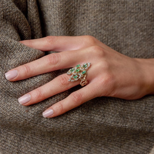 A bold and glamorous statement from the 1970s, this striking cocktail ring showcases six vivid marquise cut emeralds...