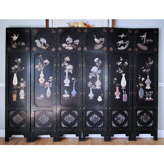 Magnificent Chinese export six panel folding coromandel screen featuring hand-carved soapstone and hardstone decoration....