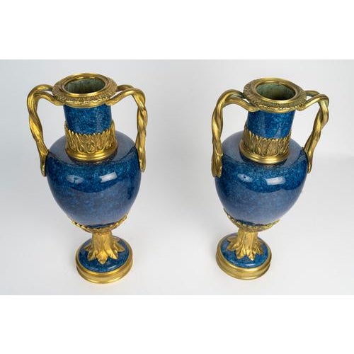 Pair of blue ceramic and gilded bronze vases, louis xvi style. Pair of early 20th-century vases, louis xvi style, in blue...