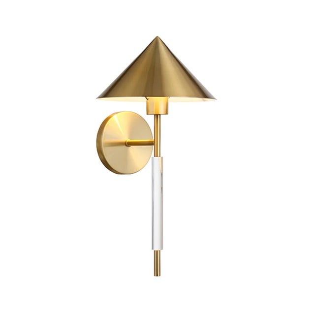 The Talon wall sconce with an acrylic pole and an antique brass triangular metal shade is a modern and sophisticated....