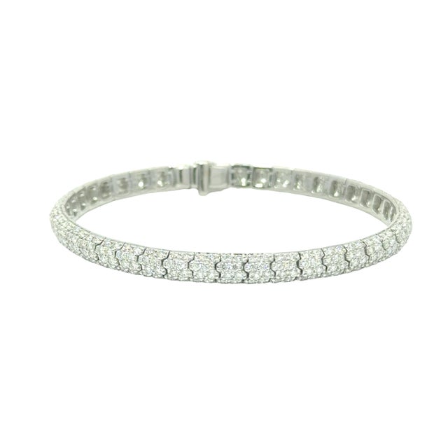 A contemporary tennis bracelet featuring 6.72 carats of round white diamonds pave set. The diamonds are set in 18k white...