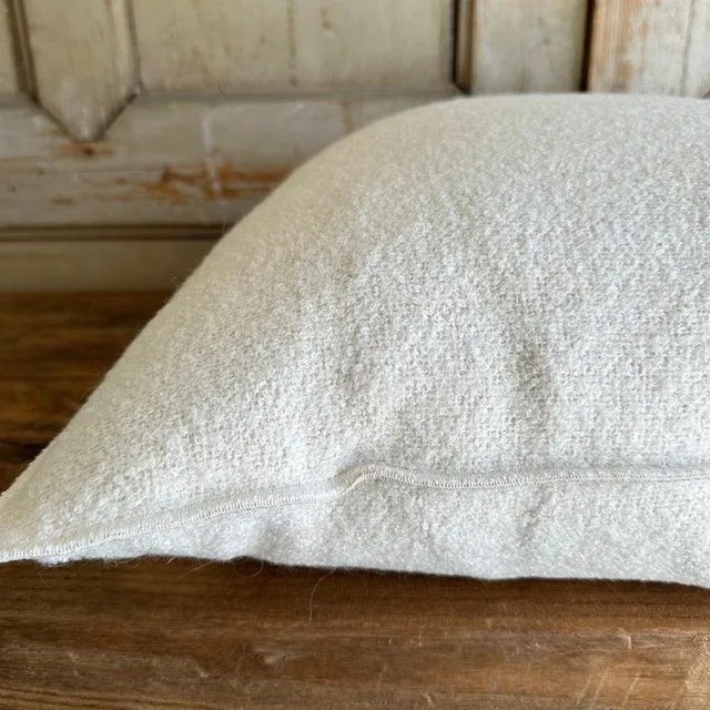 Bouclette French wool accent pillow. Custom wool blend accent pillow with down insert Color: blanc, an off white colored...