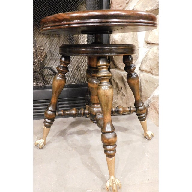 A rare Victorian swivel piano stool manufactured by the Melvin Bancroft Company of Lowell, Massachusetts, circa 1890. The...
