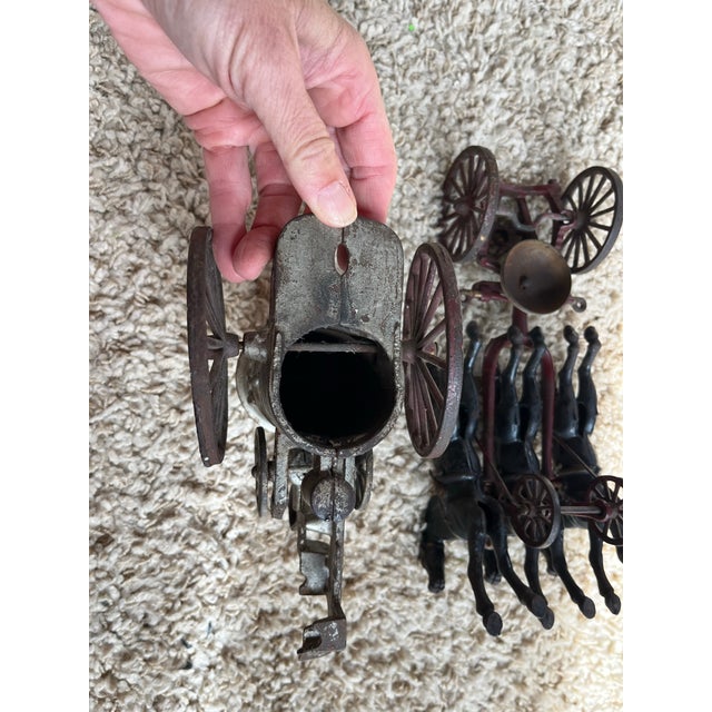 • An authentic, early 20th-century cast iron horse-drawn steam fire engine pumper wagon, measuring 18 inches long....
