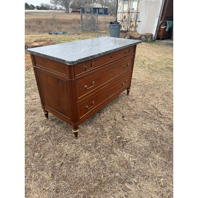 19th Century French Louis XVI Commode from France. Made of solid mahogany, with a grey marble top, the wood has been...