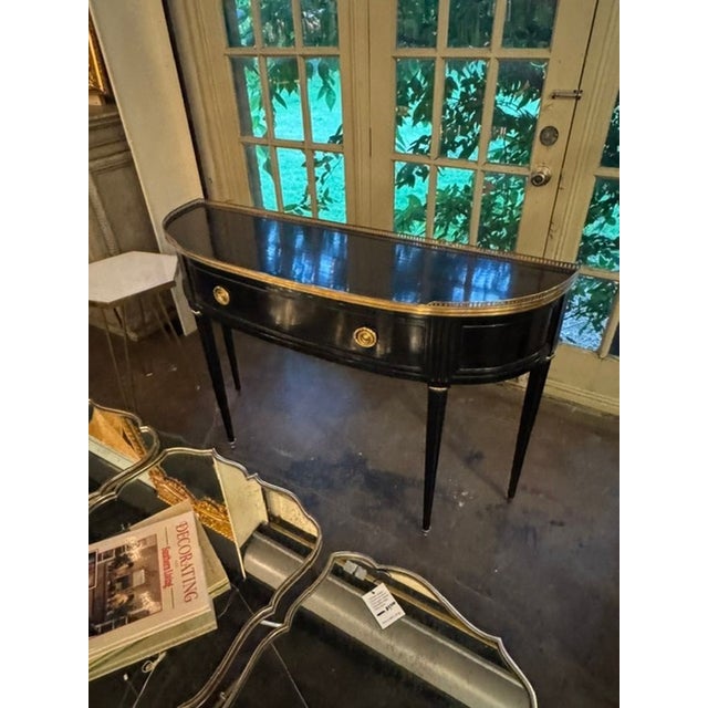 The Vintage French Jansen Design Black Lacquered Console is a stylish and elegant piece of furniture. This console exudes...