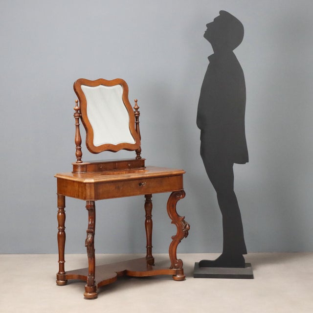 Louis Philippe walnut dressing table. Tilting beveled mirror supported by a pair of turned columns and a pair of drawers...