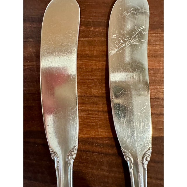 Four silver plated butter knives by Reed & Barton. Marked "Reed & Barton" on the reverse with a very small, barely...