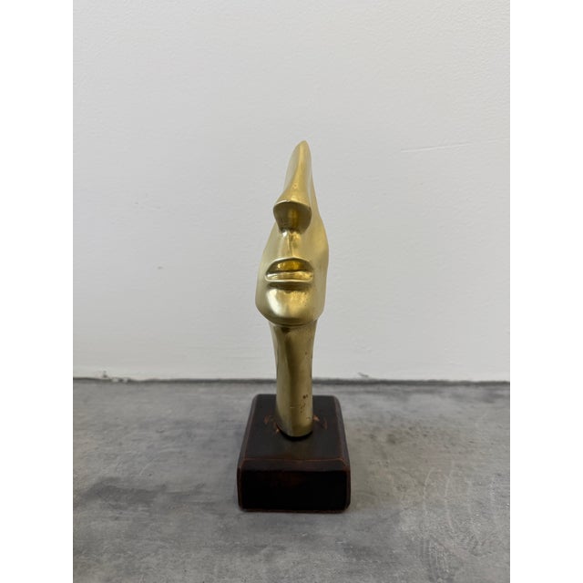 Brazilian modernist bronze sculpture of a partial face mounted on a wood base. Artist unknown. Circa 1990s.