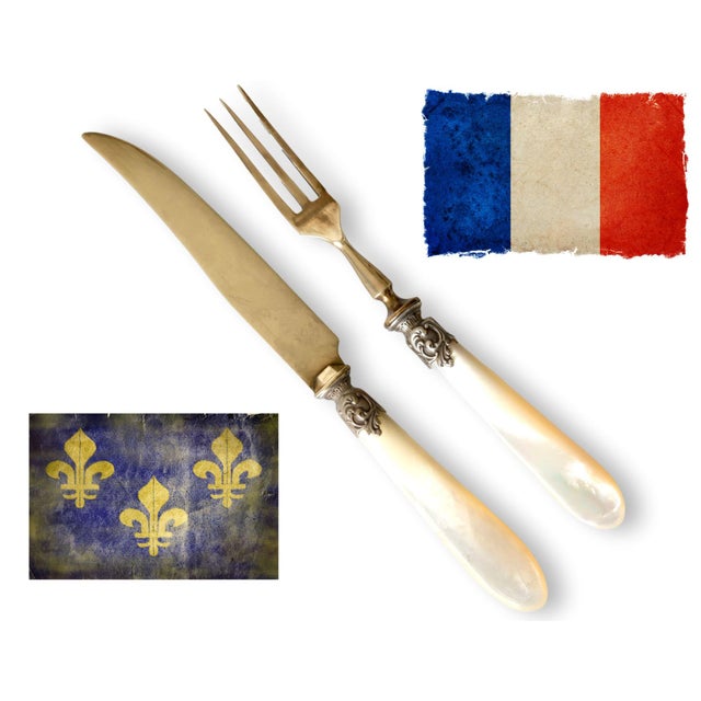 19th century French dessert or pastry service featuring luminous mother of pearl handles with decorative silver mounts and...