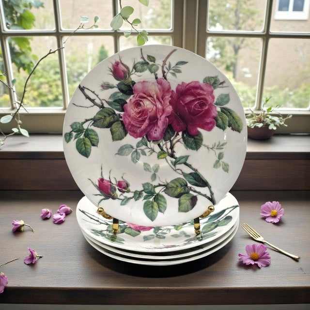A coordinated set of four oversized bone china saucers in Roy Kirkham’s “English Rose” pattern, produced in England in...