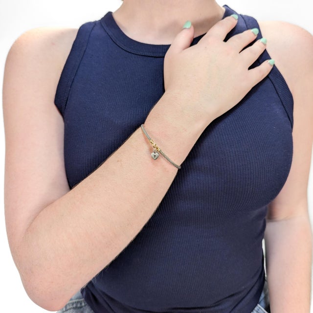 A fine signed silver and gold bracelet. By David Yurman. In sterling silver with 14 karat yellow gold accents. With a...