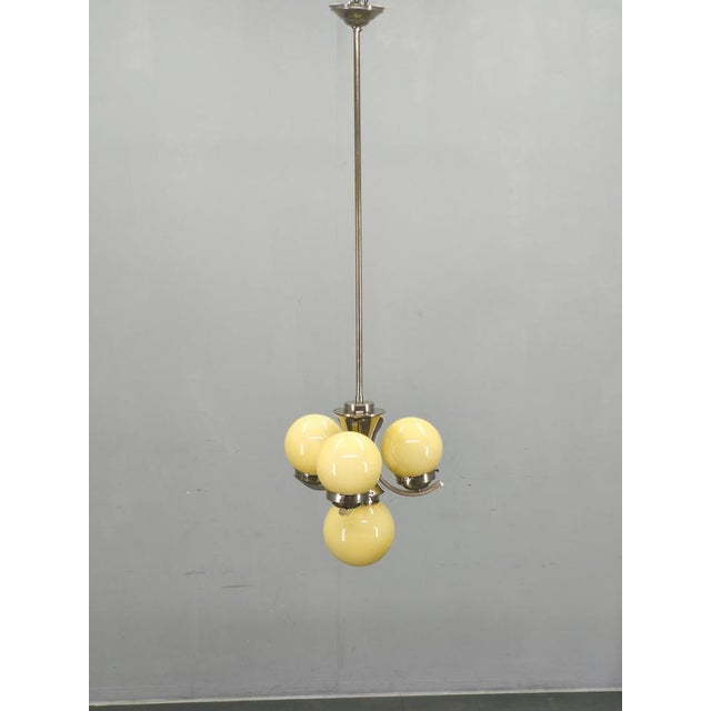 Elegant art deco chandelier produced in czechoslovakia during the 1930s, combining refined functionalist geometry with...