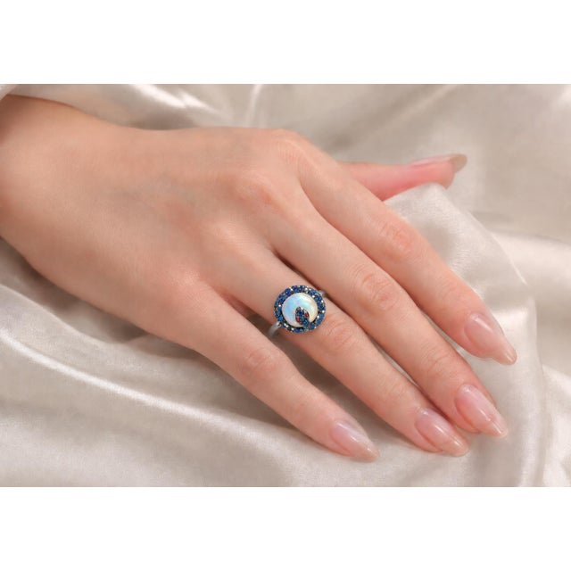 14K white gold designer ring featuring a large polished chalcedony quartz center stone (~14mm), accented with natural...