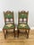 A decorative pair of Antique French chairs in Oak, featuring carved crest details, turned spindle elements and green...