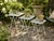 A delightful set of three vintage graduated metal nesting tables featuring white painted finishes, open diamond-mesh tops...
