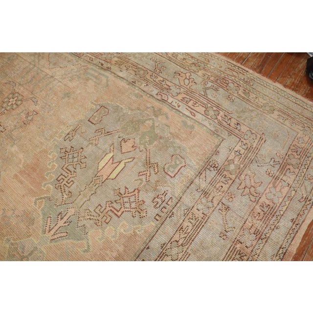 An early 20th-century oversize Turkish Oushak rug Measures: 11'2'' x 16'5" Oushak rugs originated in the small town of...
