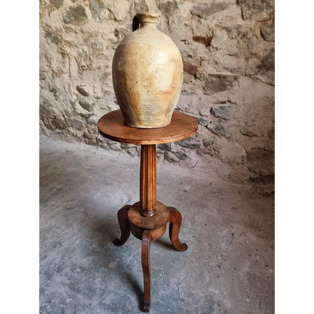 An antique French plant stand dating from around 1900. Crafted from solid walnut, this elegant guéridon features a...