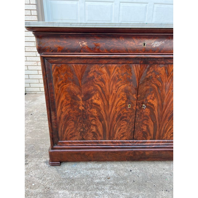 This elegant French 19th century Louis Philippe buffet is crafted from richly figured flame mahogany and crowned with its...