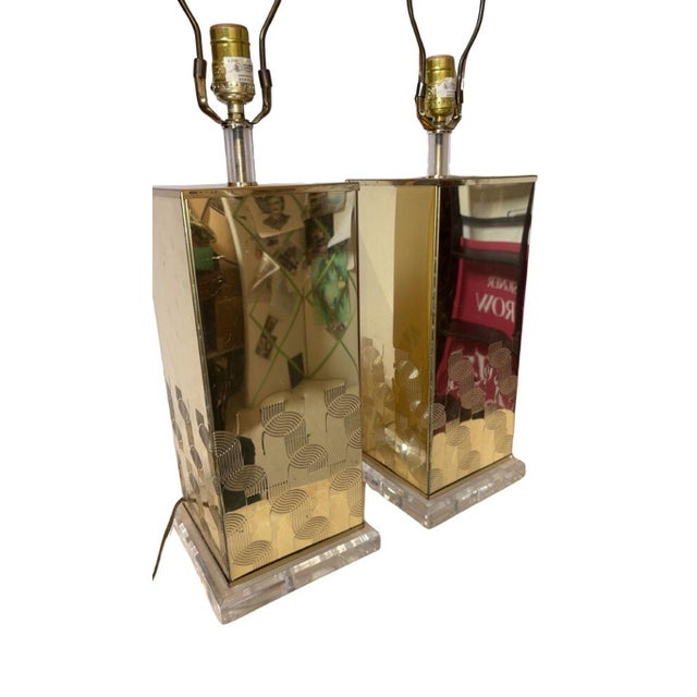 Pair of squared, Pierre Cardin style Italian brass and lucite lamps, circa 1970’s. These pieces feature a stamped...