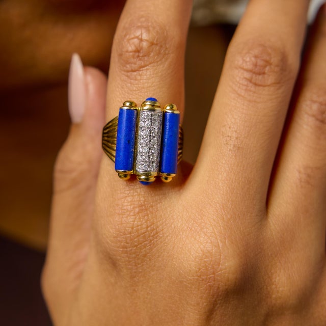 This vintage cocktail ring is a striking expression of color, contrast, and confident design. At its center rests a...