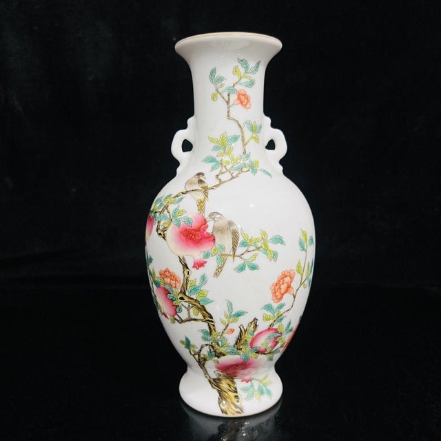 This is a matched pair of elegant vintage porcelain vases featuring classic Famille Rose enamel decoration. Each vase is...
