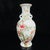 This is a matched pair of elegant vintage porcelain vases featuring classic Famille Rose enamel decoration. Each vase is...