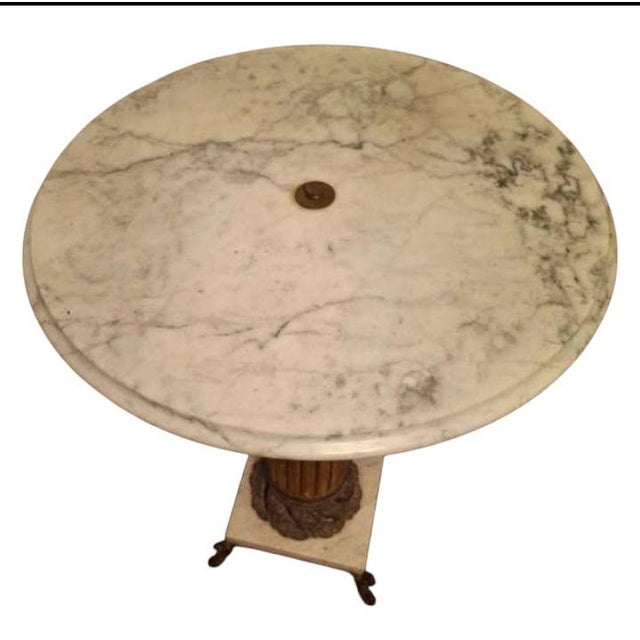 Elevate your space with this exquisite Neoclassical pedestal Italian marble top table a timeless European elegance. This...
